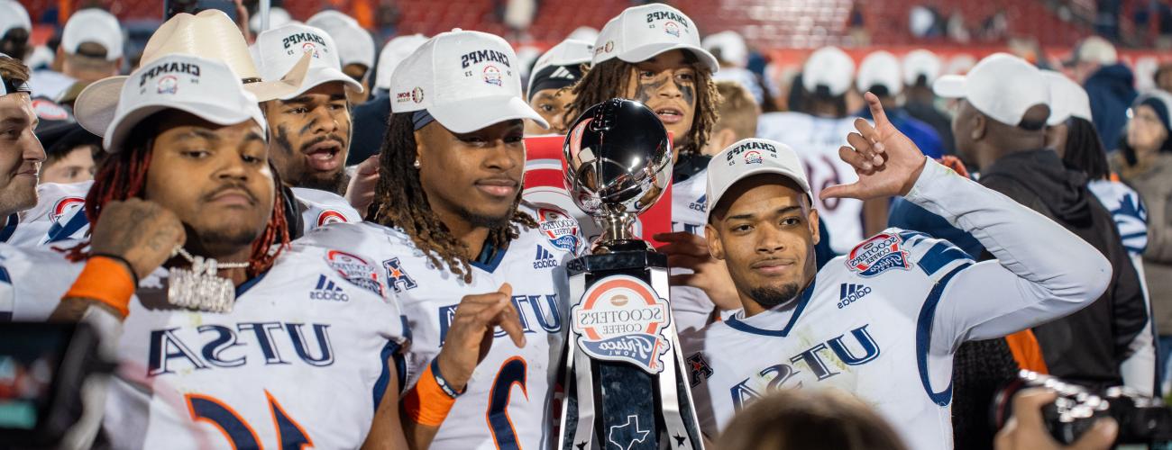 Football players posing with trophy